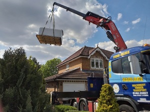 Lifting hot tub over a garage to install into to back garden